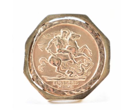 A hallmarked 9ct gold St George ring. The ring having a round panel to the centre with repousse George and the dragon motif w