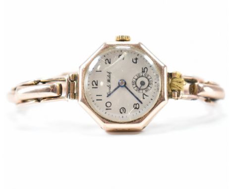 An early 20th Century Edwardian 9ct gold Ovale wirst watch. The have having an octagonal face with arabic numerals to the cha
