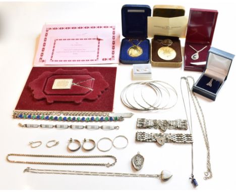 A collection of silver and white metal jewellery to include a windmill charm necklace four silver bangles, two silver gate li