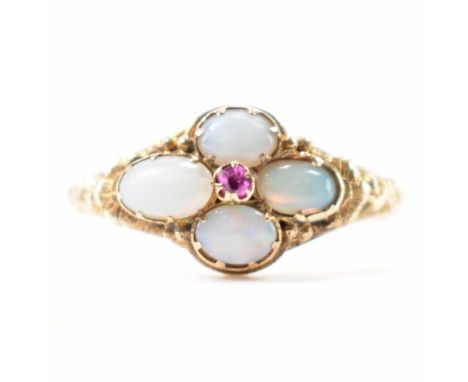 An early 20th century Edwardian era gold opal and ruby ring. The ring having a central round cut ruby with four oval cut opal