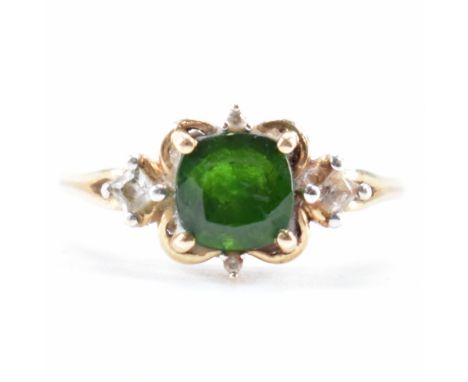 A hallmarked 9ct gold and tourmaline ring. The ring being set with a square cushion cut tourmaline with white accent stones. 