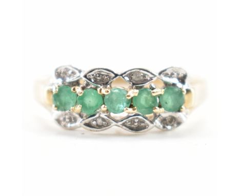 A vintage gold emerald and diamond ring. The ring being set with five round cut emeralds with diamond accent stones set alter