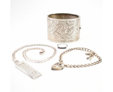 A collection of silver jewellery. The lot to include a silver and blue stone ring (marked 925, size L.5), a silver heart lock