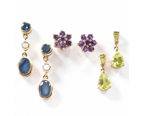 An assortment of three pairs of gold stone set earrings to include a pair of green stone drop earrings, a pair of purple ston