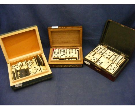 Two sets of Dominoes in three decorative trinket boxes 