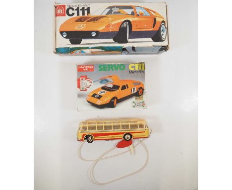A group of boxed Eastern European battery operated toys comprising an unboxed bus, a smaller scale Mercedes C111 (both remote