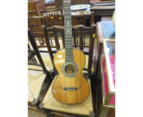 A late Victorian acoustic Guitar having feathered stringing and mother of pearl inlay