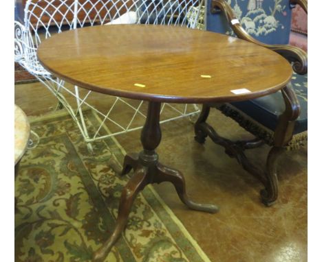 An antique Pillar Table in faded mahogany with tilt top on turned column and tripod base