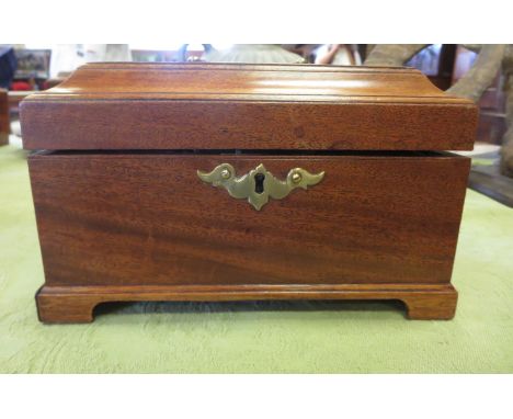 A George III mahogany Tea Caddy of sarcophagus shape with original three interior metal containers on bracket feet, 9in