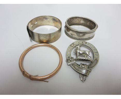 A 9ct gold plain Bangle, a Scottish Kilt Brooch by Jamieson, Aberdeen, and two silver Bangles