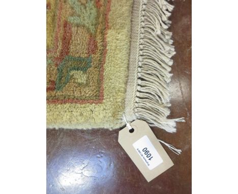 An Indian Raja hand knitted wool pile Carpet with floral design on a camel ground, 9ft x 6ft