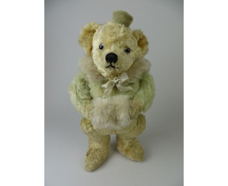 A fine and rare green and gold mohair and silk plush Chiltern Skating Bear with muff. Painted back eyes. Nice condition. Rema