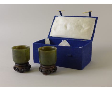 A pair of jade Pen Washers, cylindrical with slightly flared rims low foot rims, 1 3/4 in H, on wooden stands