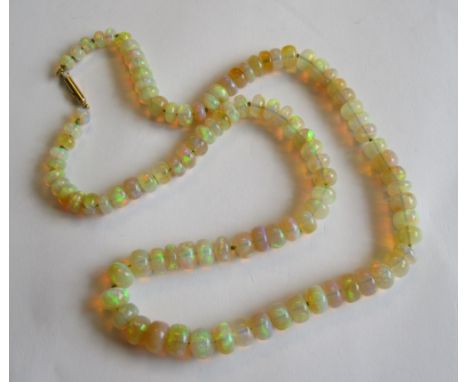 A single row of graduated Opal Beads on barrel clasp marked 9ct