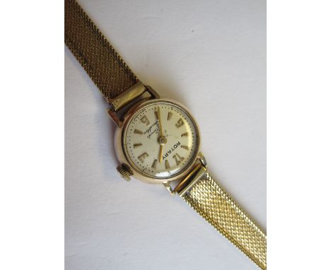 A Lady’s Rotary Wristwatch, the champagne dial with arabic numerals and chevron markers on 9ct gold ribbon effect bracelet