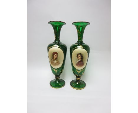 A pair of 19th Century Bohemian green glass slender Vases with oval portrait reserves and gilt detail, 15in, both drilled, an