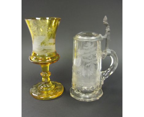 A Bohemian glass Tankard with engraved scene of deer in a forest, with pewter mounted lid and a yellow glass Goblet engraved 