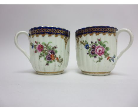 Pair of early Worcester fluted polychrome Cups painted floral sprays, blue and gilt rims, crescent mark