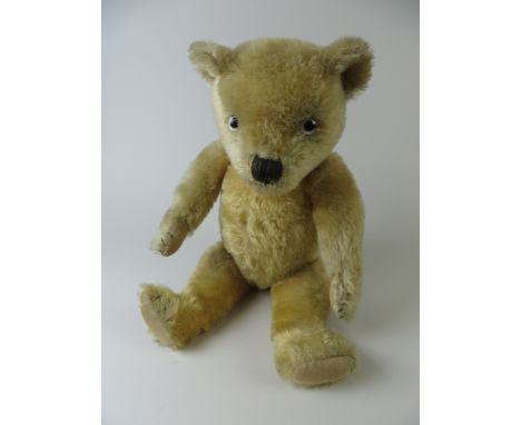 A golden Chiltern Hug Me Bear with painted back eyes and original pads. Fully jointed. 1930’s. 20in H