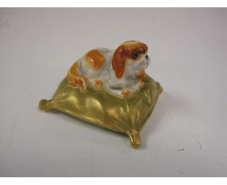 A Royal Worcester Figure of a King Charles Spaniel, lying on a shot-gold cushion, date code 1908, 1 3/4in square