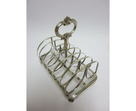 A Victorian silver seven bar Toastrack with central handle on scroll feet, Sheffield 1838, maker: Henry Wilkinson & Co