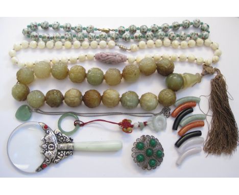 A carved hardstone Bead Necklace, a string of enamelled Beads, a string of Beads with carved purple jade type elongated centr