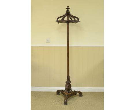 A Victorian mahogany Coat Stand with circular top mounted with hooks on turned column and carved tripod base, 6ft H