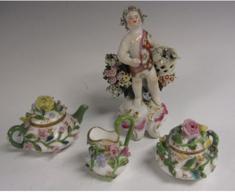 A Continental miniature Tea Service with floral and leaf decoration viz: Teapot, lidded Sucrier and Jug, and a Bow type Figur