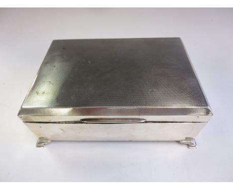 A George VI large silver Cigarette Box with engine turning on bracket feet, Birmingham 1939