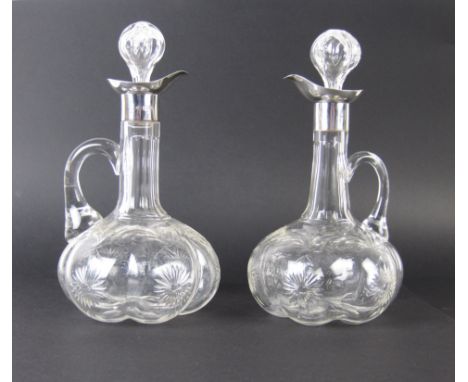 A pair of Edwardian cut glass silver mounted Claret Jugs each of lobed globe and shaft form with floral design, London 1906, 