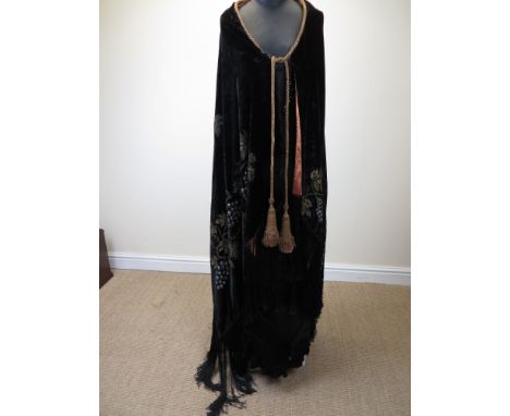 A fine black silk velvet Evening Cloak with painted and embroidered grapes and vine leaves. Long fringe. Lined in orange. c19