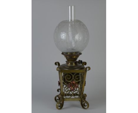 An Arts and Crafts Oil Lamp with etched shade, scrolled designs and copper flower heads, 19in H