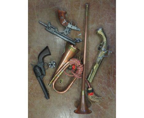 A reproduction Colt .45, another long barrel, a brass Ornament Percussion Pistol, post Horn and a Bugle