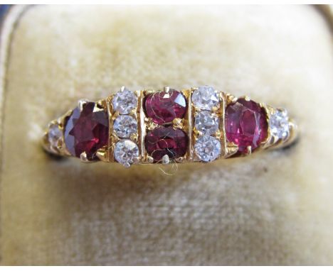 A Ruby and Diamond Ring pavé-set four circular-cut rubies interspersed with old-cut diamonds in 18ct gold, ring size S 