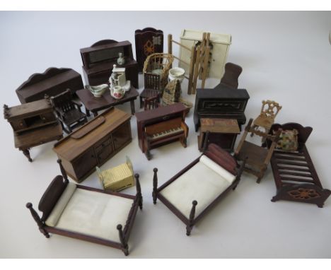 A large quantity Dolls House Furniture including a pair of beds stamped Germany, medieval style armchair, two pianos, a burea