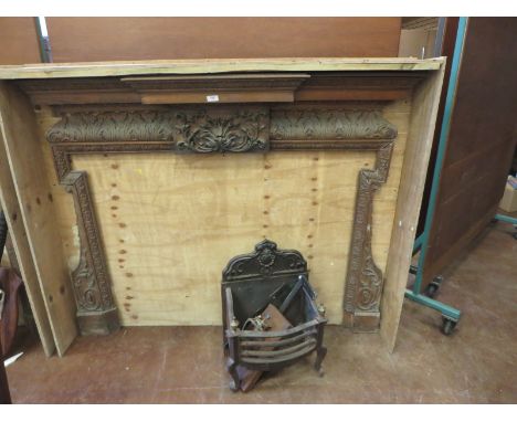 An antique pine Fire Surround having breakfront mantelpiece and carved acanthus leaf frieze, 5ft 8in wide, together with cast