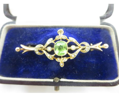 A 15ct gold Brooch/Pendant set with peridot and seed pearls, (one pearl missing), Chester 1909