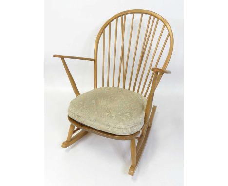 An Ercol blond elm stickback rocking elbow chair, model No. 315, with typical dished seat, w.73.5cm 