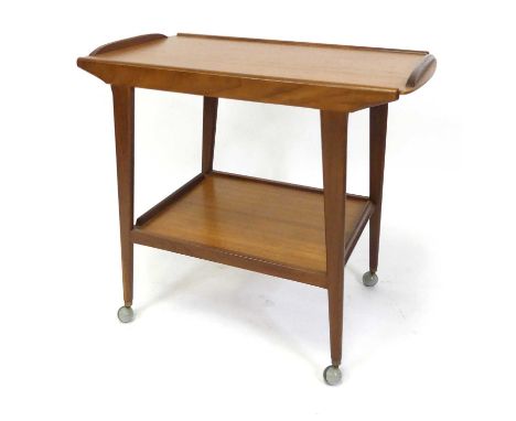 A 1970s Danish teak two-tier tea trolley, each tier having a raised edge, on curved tapering supports to roller castors, h.67