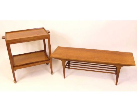 A 1970s teak two-tier tea trolley, having removable twin handled upper tray with laminate underside, further removable lower 