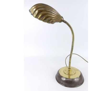 An early 20th century brass banker's style desk lamp, having stylised scallop shell shade, adjustable branch arm, and raised 