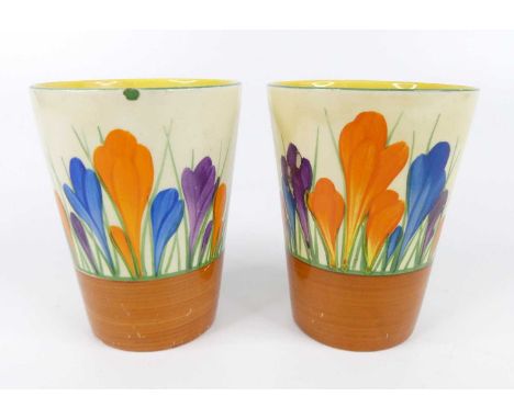 A pair of 1930s Clarice Cliff Crocus pattern pottery beakers, each of cylindrical tapering form, bright colour decorated, bla