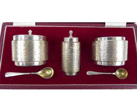 A 1970s silver three-piece cruet set by Mappin &amp; Webb, comprising; salt, pepper and mustard pot, each of cylindrical barr