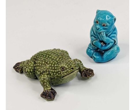 A Burmantofts turquoise glazed 'faience' model of a monkey, shown in seated pose, having later glass eyes, impressed marks an