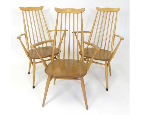 A set of three 1960s Ercol blond elm 'Goldsmith Windsor' elbow dining chairs, model No. 369A, raised on turned tapering suppo