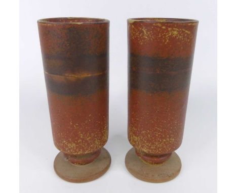 Robin Welch Pottery - a pair of studio pottery cylindrical footed vases, decorated in tones of crimson, impressed marks to un