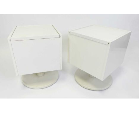 A pair of contemporary white laminate cube shaped bedside tables, each with sliding top and raised on a circular pedestal, h.