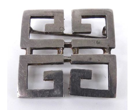 A sterling silver Givenchy geometric monogram brooch, comprising four letter G's arranged in a square, with roller catch fast