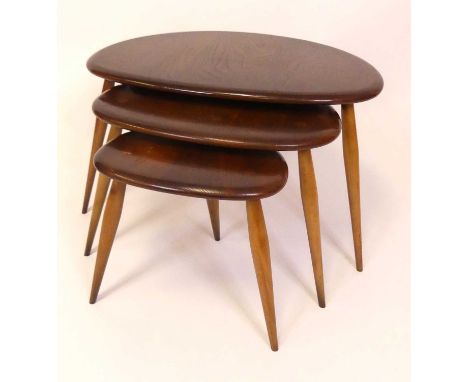 An Ercol dark elm nest of three 'Pebble' occasional tables, model No. 354, each on turned tapering supports, the largest h.40