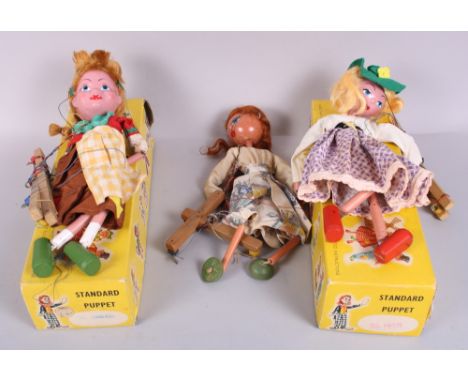 Two standard Pelham puppets, "Mitzi" and "Gretel", in boxes, and another puppet, unboxed